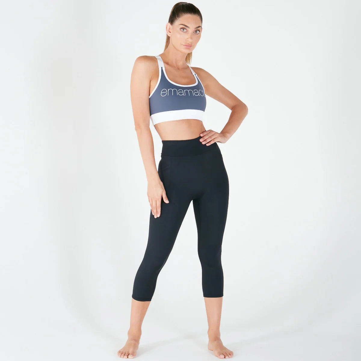 Woman in blue sports bra and navy capri leggings showcasing fit everyday leggings