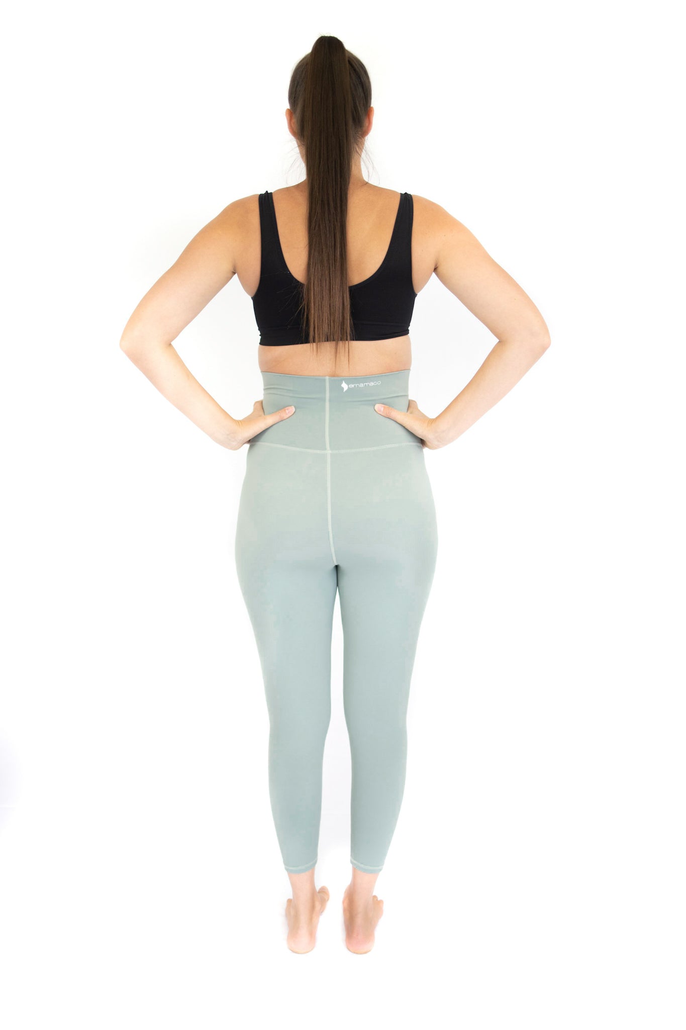 Woman showcasing Emamaco maternity leggings in light blue, perfect for comfort and style