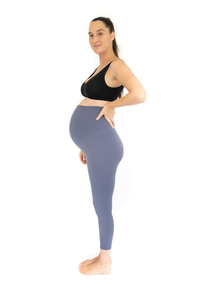 Pregnant woman in black sports bra and blue Emamaco Maternity Leggings - Twilight