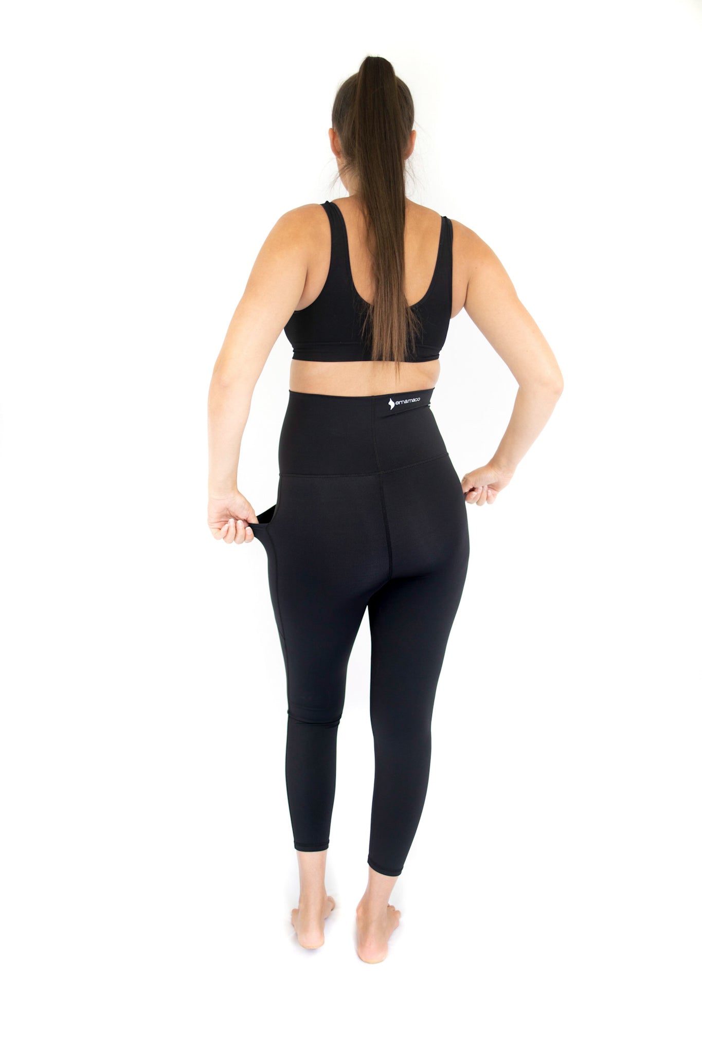 Woman in black emamaco maternity leggings viewed from behind during workout