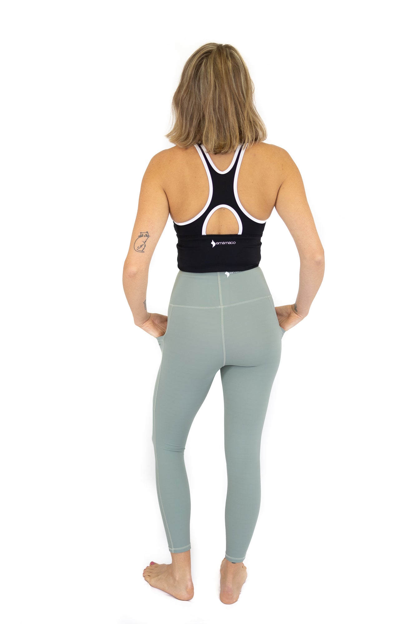 Woman in athletic attire displaying 7/8 Shaper Move Leggings in Spearmint on final sale