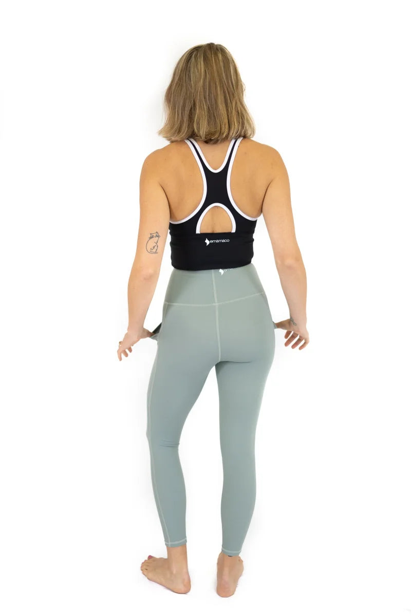 Woman in athletic attire showcasing 7/8 Shaper Move Leggings in Spearmint - Final Sale