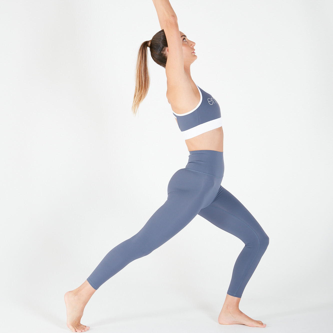 Woman in blue activewear performing yoga in 7/8 Shaper Move Leggings - Twilight