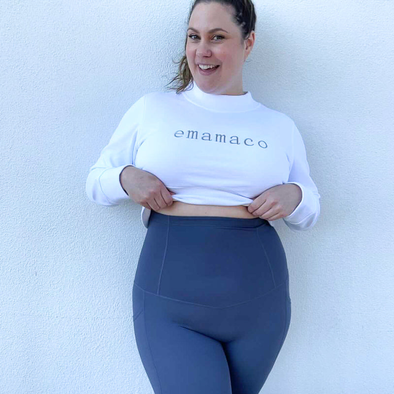 Smiling woman in emamaco sweatshirt and Body Shapewear Leggings in Twilight Blue