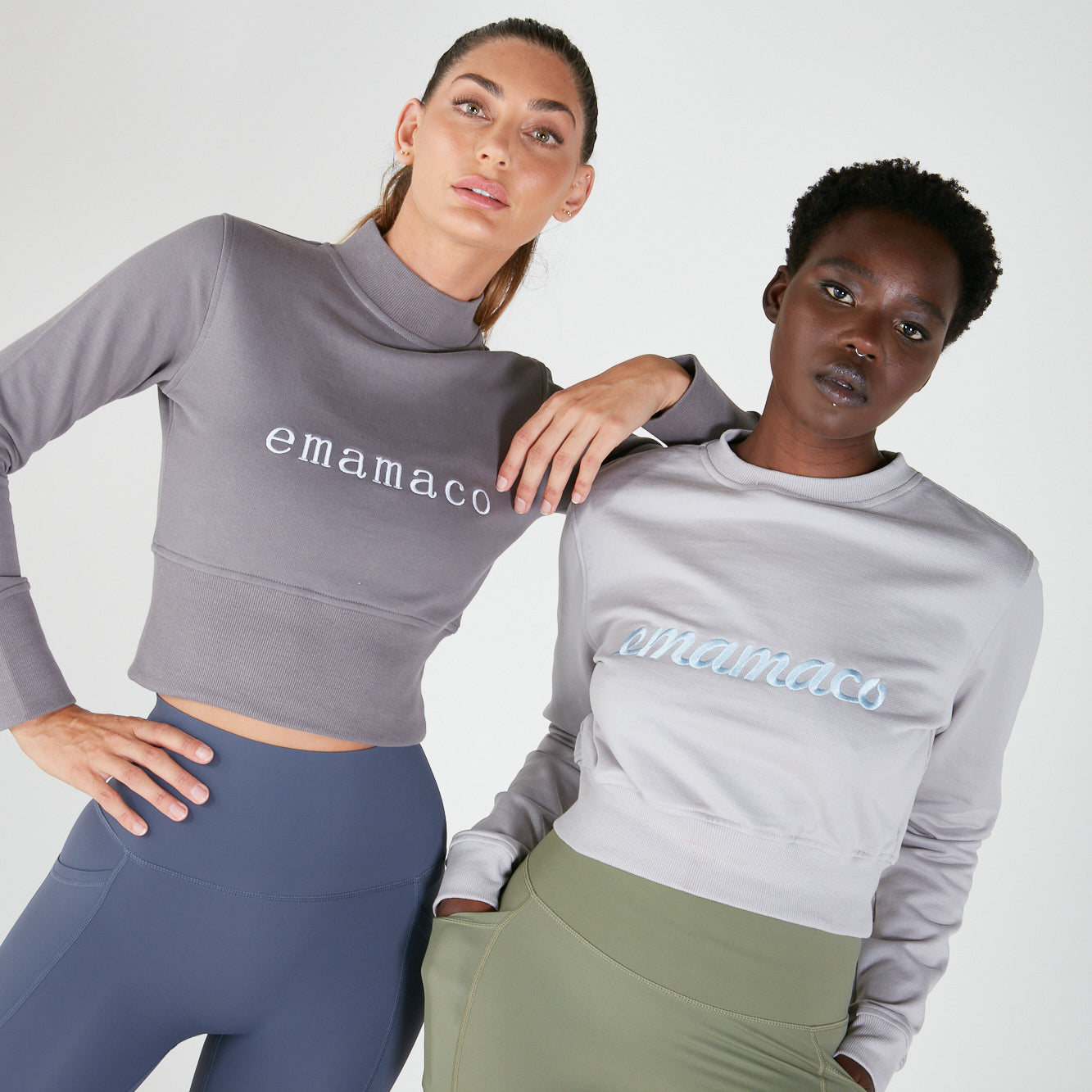 Two women in activewear showcasing Cropped Sweat maternity tops with printed text