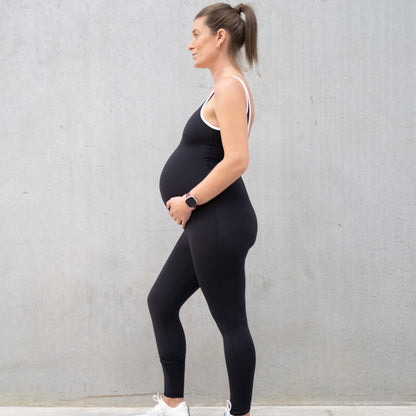 Pregnant woman in black athletic bodysuit designed for comfort during maternity wear