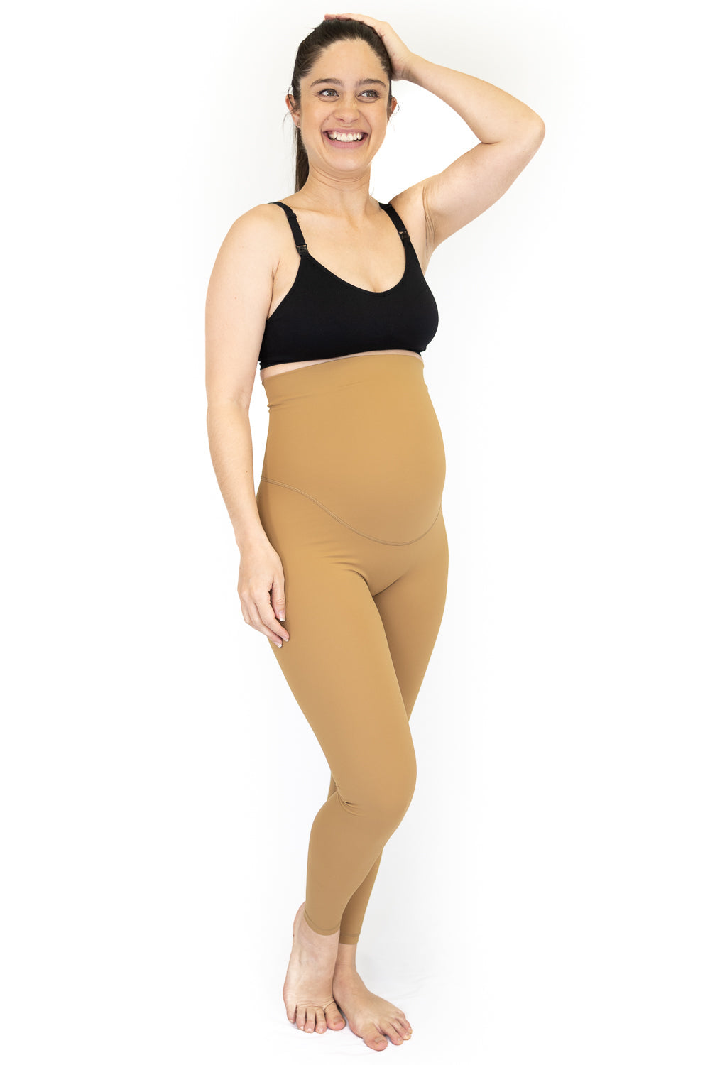 Woman in black top and beige Emama Maternity Leggings, smiling on final sale