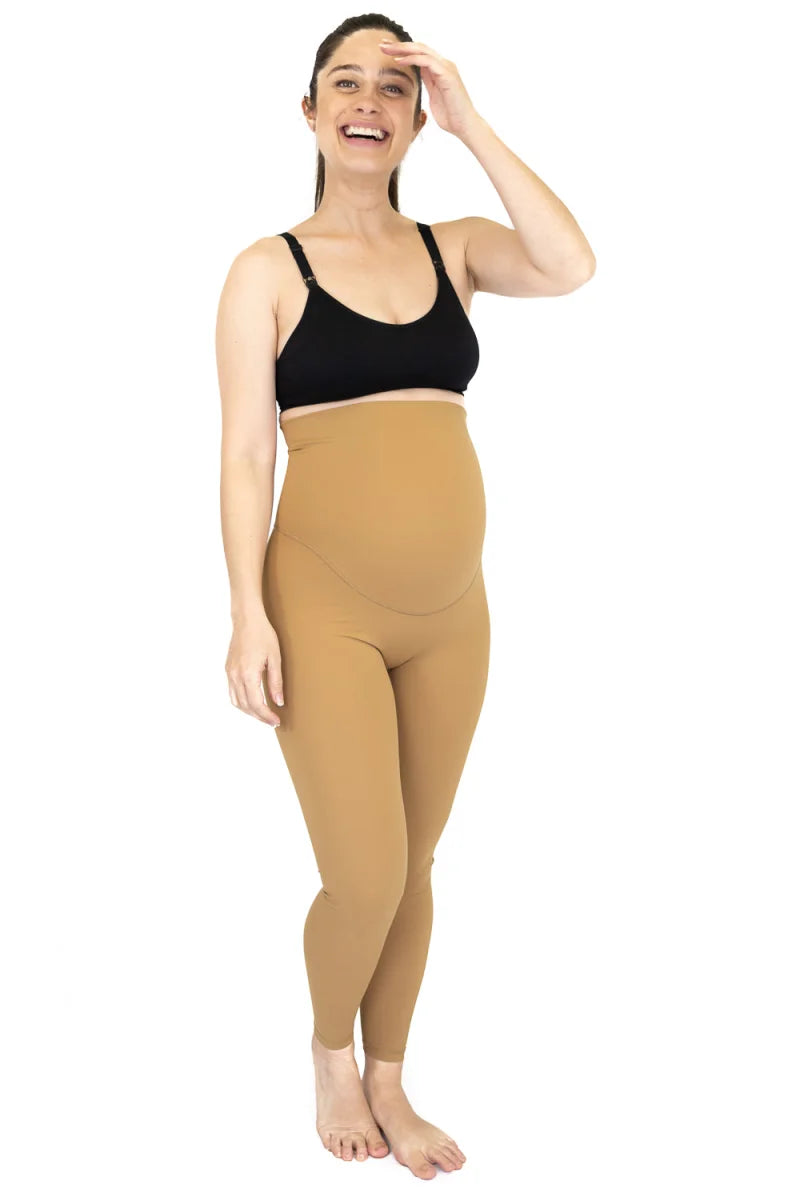 Woman in black sports bra and high-waisted beige Emama Maternity Leggings on final sale