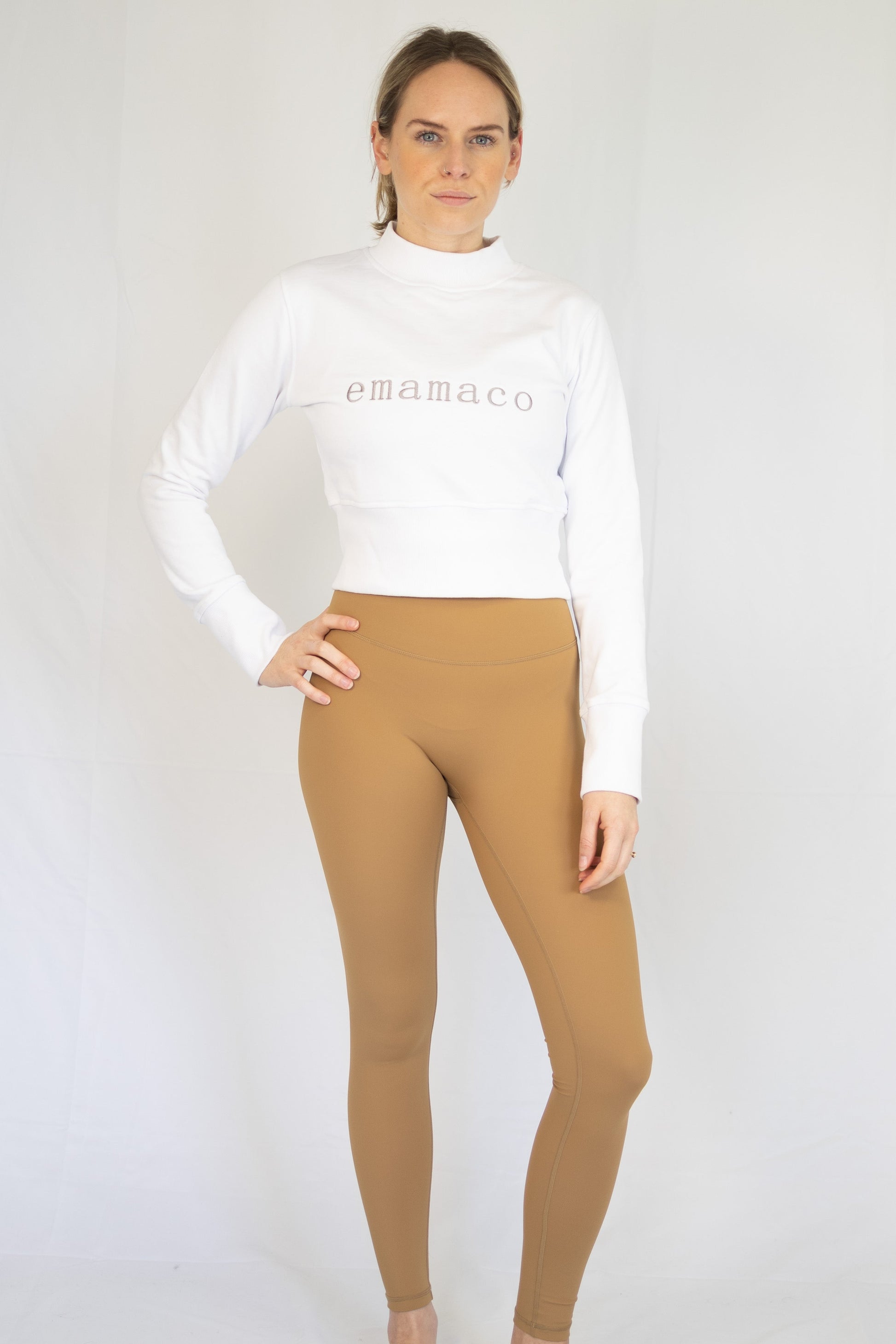 Woman in white crop top and tan Shaper Move Leggings - Final Sale, limited sizes remaining