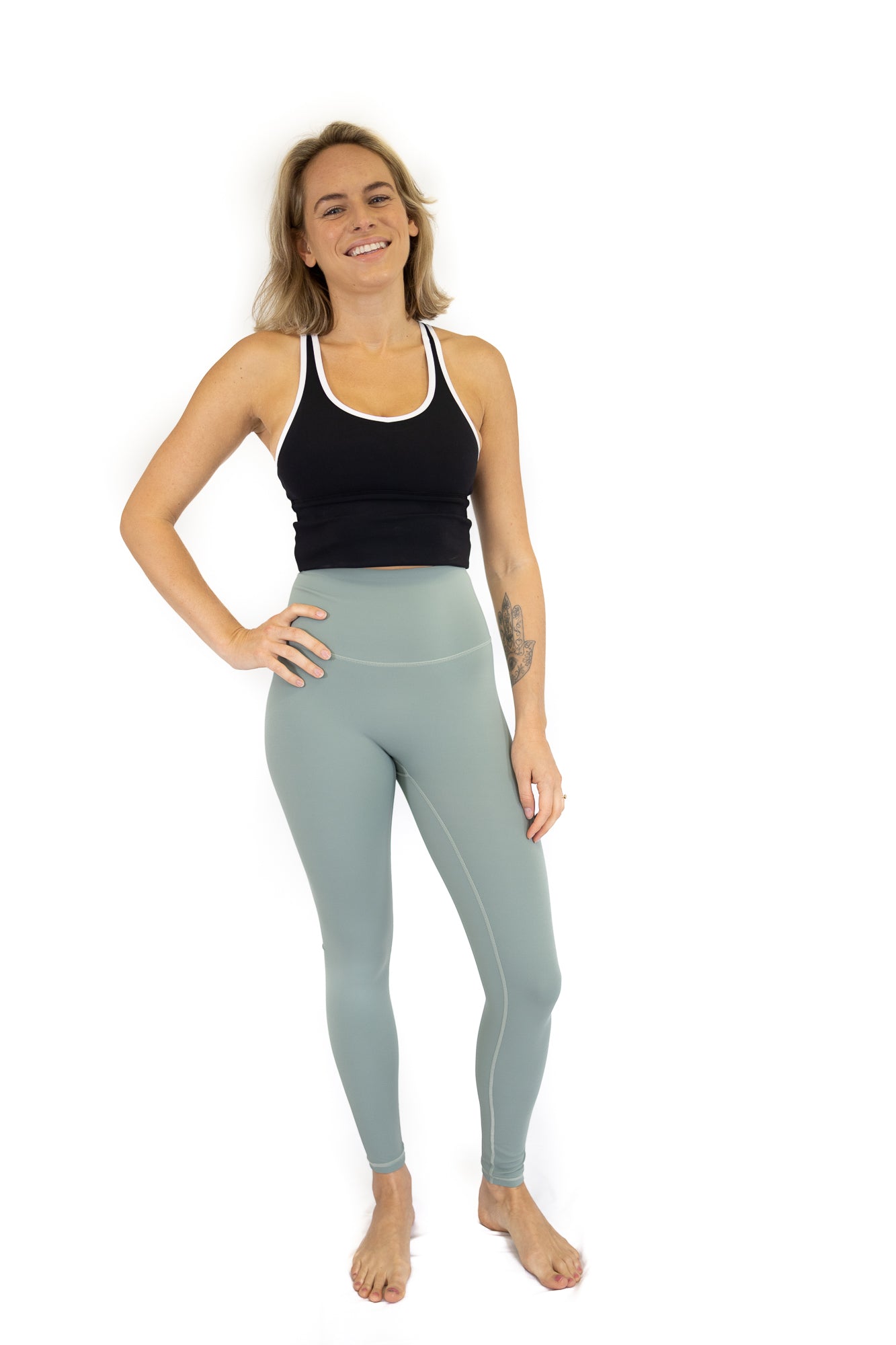 Woman in black tank top and light blue Shaper Move Leggings, ideal maternity activewear