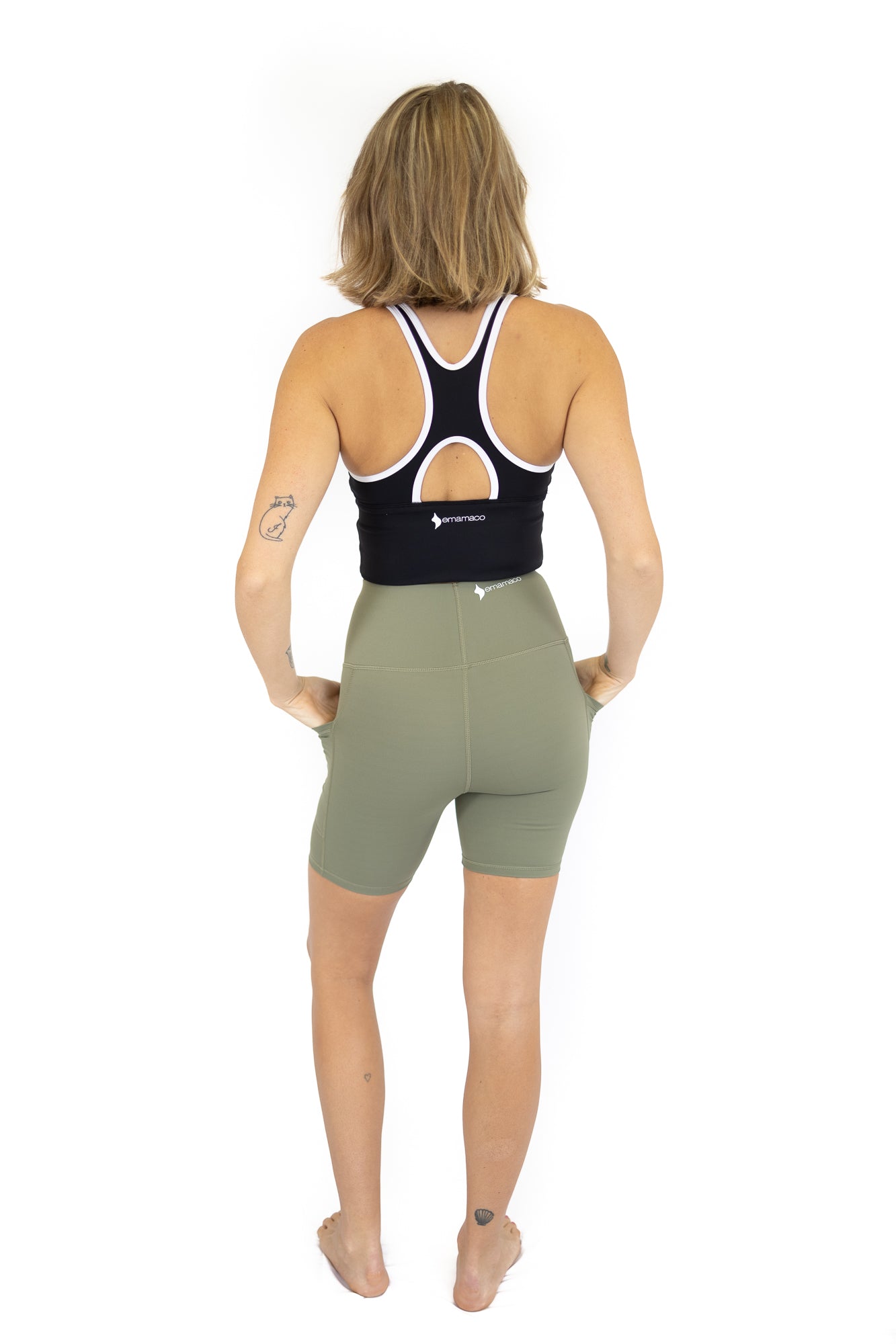 Woman in athletic clothing seen from behind wearing Shaper Move Shorts - Final Sale