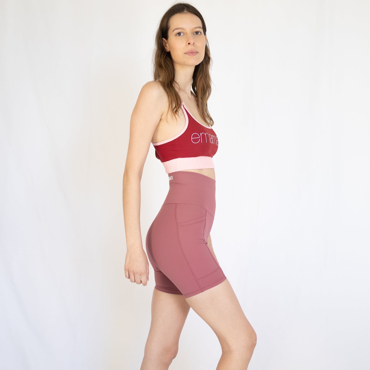 Woman in red and pink Shaper Move Shorts + Pockets activewear for maternity workouts