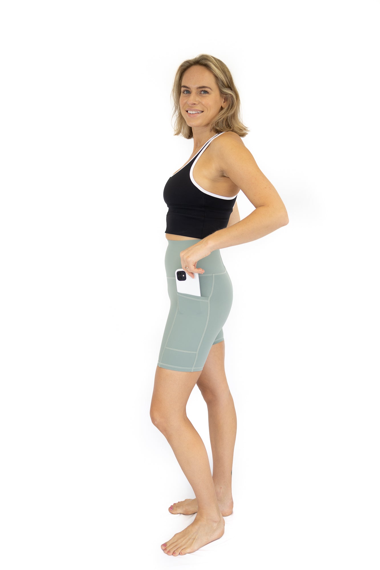 Woman in black crop top and light blue Shaper Move Shorts on final sale