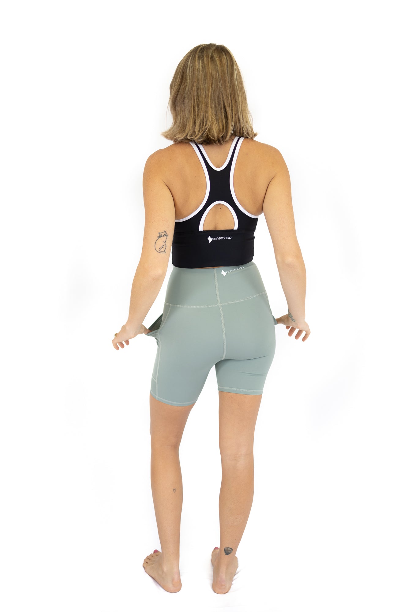 Woman in athletic wear showcasing Shaper Move Shorts in Spearmint on final sale