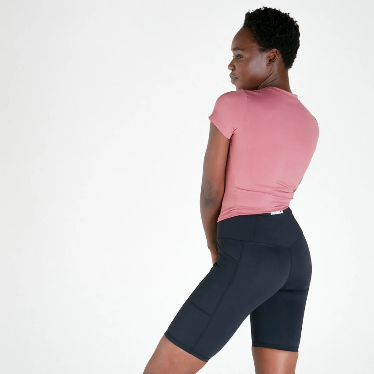 Woman in a pink TSHIRT - ROSE and dark cycling shorts made of supaflex material