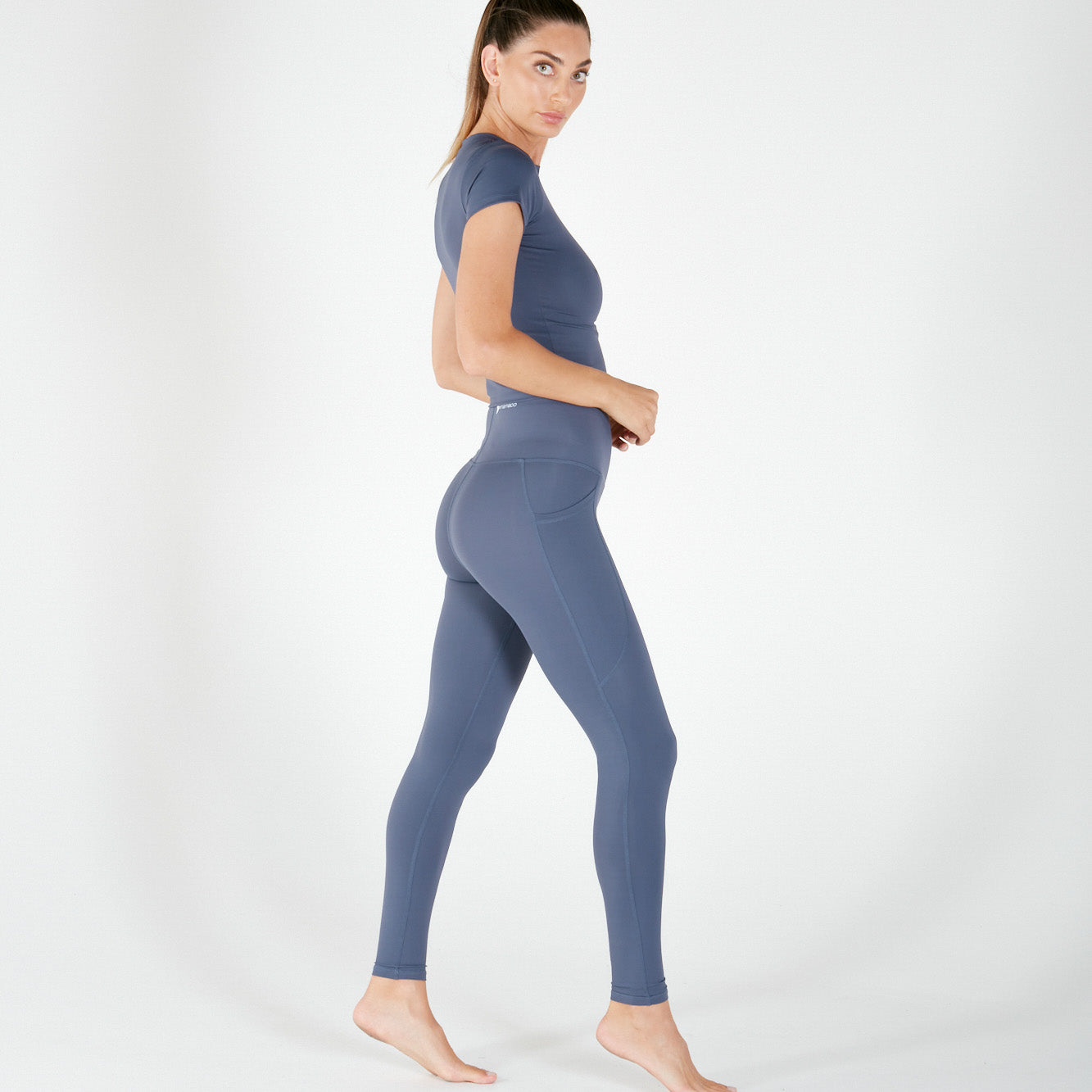 Woman in blue-gray athletic T-shirt featuring Supaflex material, ideal maternity activewear