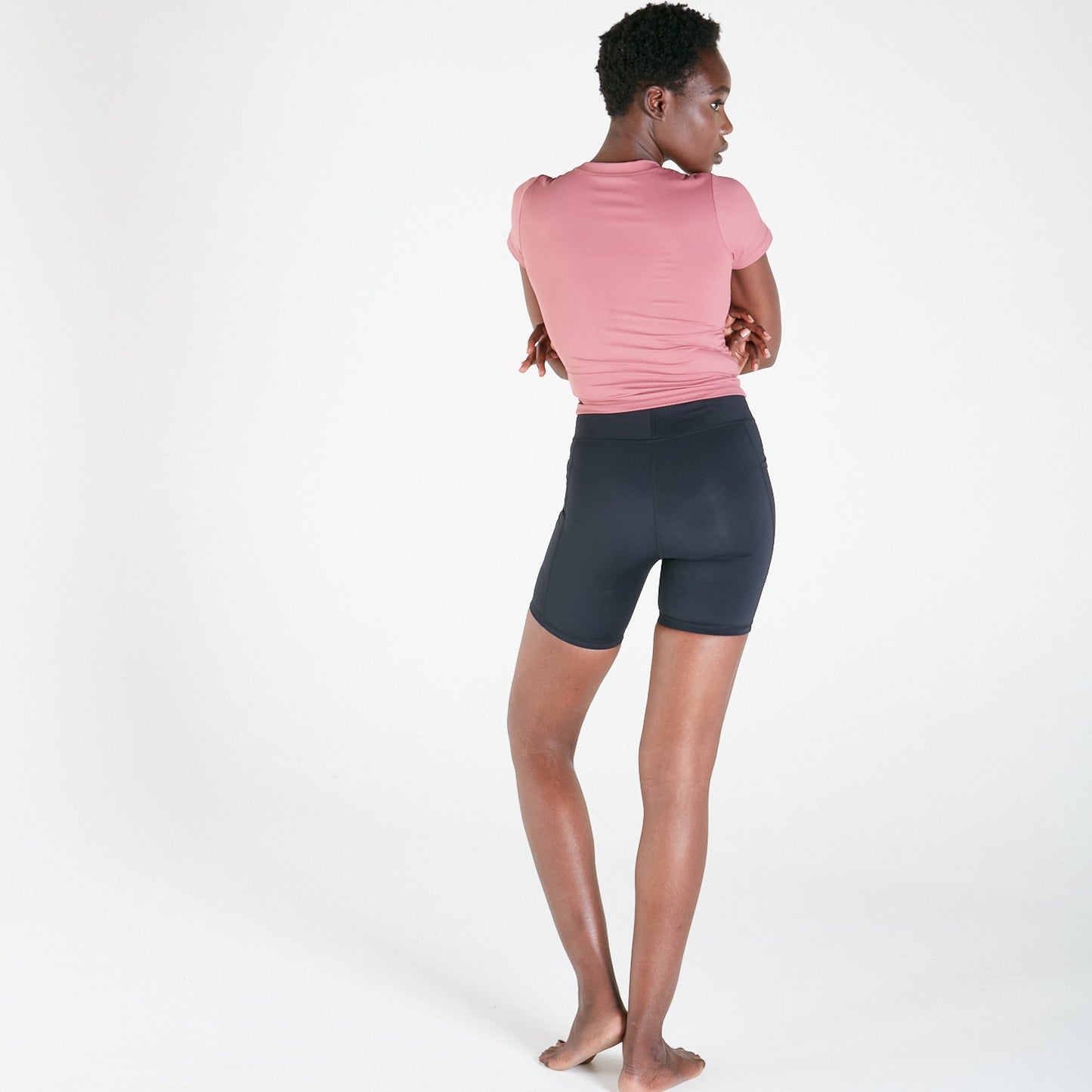 Woman modeling Vibe Shorts with pockets in Black, featuring a regular fit waistband