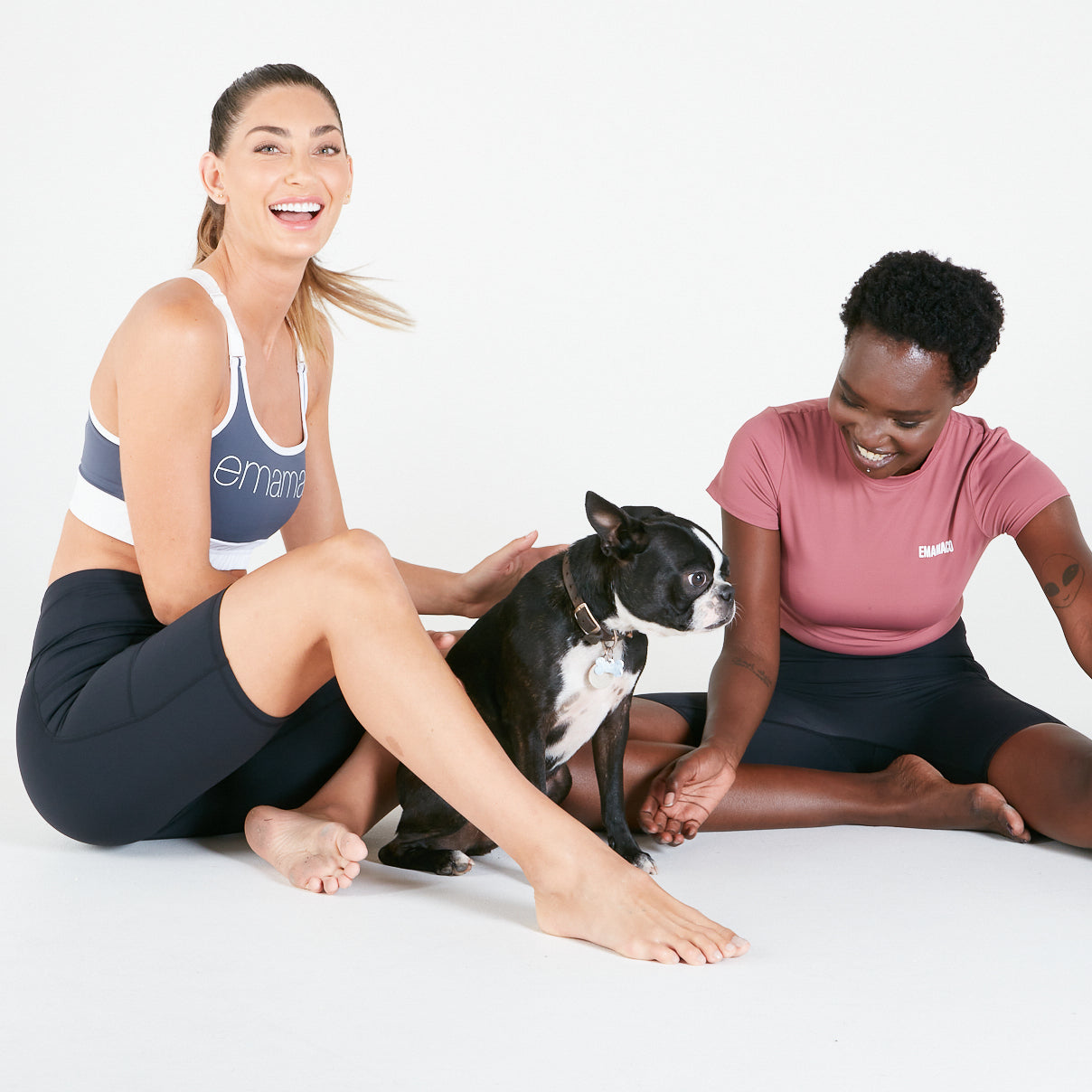 Black and white dog with two women wearing Vibe V Back Long Shorts in Black